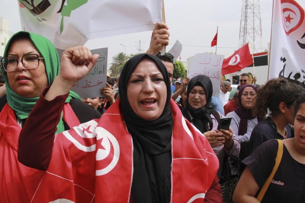 Tunisians stage anti-migrant protest as the number of stranded in transit to Europe grows