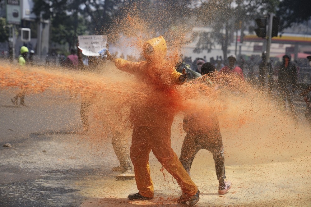 Part of Kenya's parliament is on fire as thousands of protesters enter. Several bodies are seen