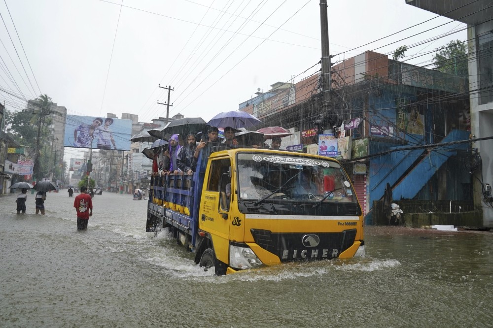 Floods maroon many people in Bangladesh and India and cause at least 15 deaths